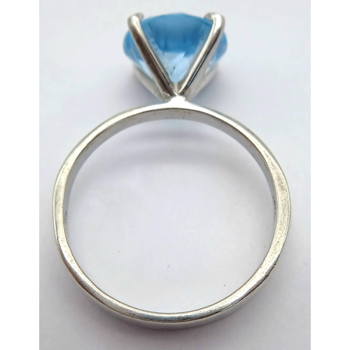 1211 - A Stylish Sterling Silver Tiffany Style Mounted Blue Topaz Solitaire Ring Size Q. The Ring is set wi... 