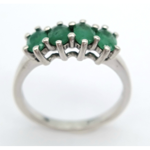 1218 - A Stylish Sterling Silver and Four Emerald Set Ring Size S. The Ring is set with Four Oval Cut 6 x 4... 
