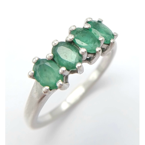 1218 - A Stylish Sterling Silver and Four Emerald Set Ring Size S. The Ring is set with Four Oval Cut 6 x 4... 