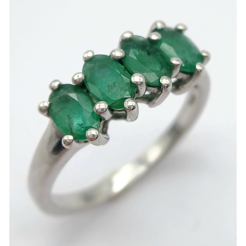 1218 - A Stylish Sterling Silver and Four Emerald Set Ring Size S. The Ring is set with Four Oval Cut 6 x 4... 