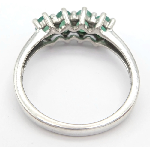 1218 - A Stylish Sterling Silver and Four Emerald Set Ring Size S. The Ring is set with Four Oval Cut 6 x 4... 