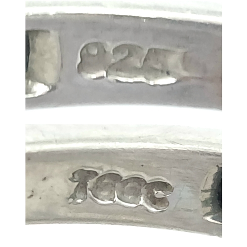 1218 - A Stylish Sterling Silver and Four Emerald Set Ring Size S. The Ring is set with Four Oval Cut 6 x 4... 