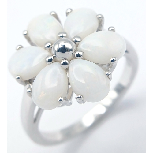 615 - A Pretty Sterling Silver and Opal Set Flower Design Ring Size T. Appears practically unworn if worn ... 