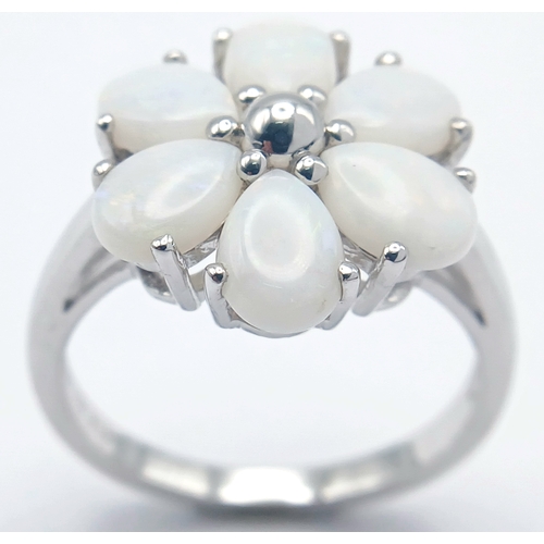 615 - A Pretty Sterling Silver and Opal Set Flower Design Ring Size T. Appears practically unworn if worn ... 