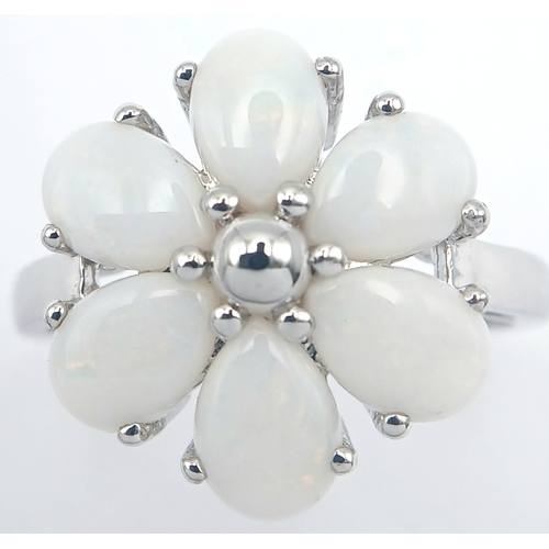 615 - A Pretty Sterling Silver and Opal Set Flower Design Ring Size T. Appears practically unworn if worn ... 