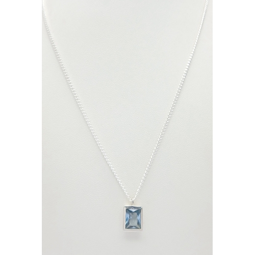 629 - A Stylish Sterling Silver Blue Topaz Pendant Necklace-46cm Length Chain. Set with a 9 x 7mm Rectangl... 