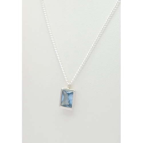 629 - A Stylish Sterling Silver Blue Topaz Pendant Necklace-46cm Length Chain. Set with a 9 x 7mm Rectangl... 