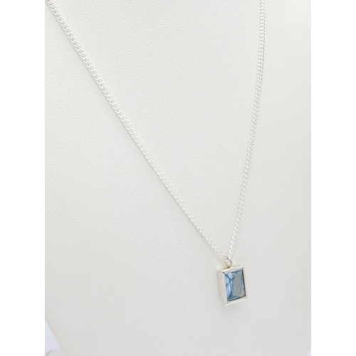 629 - A Stylish Sterling Silver Blue Topaz Pendant Necklace-46cm Length Chain. Set with a 9 x 7mm Rectangl... 