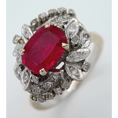 30 - A STUNNING PLATINUM DRESS RING WITH CENTRAL RUBY SURROUNDED BY QUALITY DIAMOND IN ART DECO LEAF FORM... 