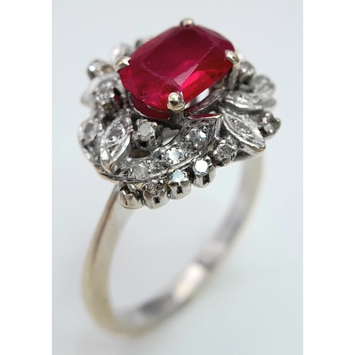 30 - A STUNNING PLATINUM DRESS RING WITH CENTRAL RUBY SURROUNDED BY QUALITY DIAMOND IN ART DECO LEAF FORM... 