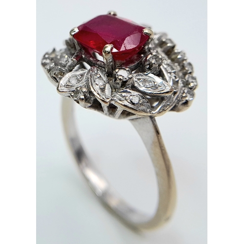 30 - A STUNNING PLATINUM DRESS RING WITH CENTRAL RUBY SURROUNDED BY QUALITY DIAMOND IN ART DECO LEAF FORM... 