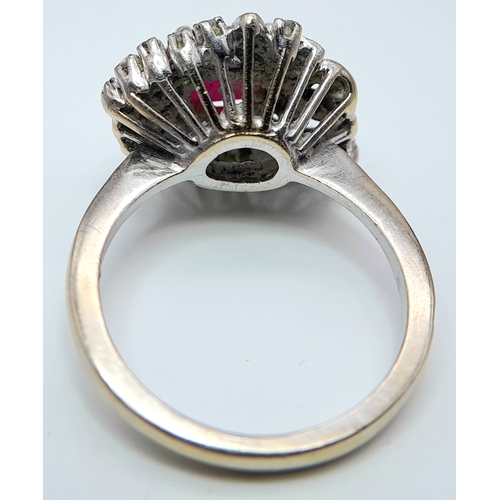 30 - A STUNNING PLATINUM DRESS RING WITH CENTRAL RUBY SURROUNDED BY QUALITY DIAMOND IN ART DECO LEAF FORM... 
