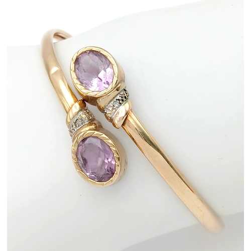 51 - A 9K GOLD TORQUE STYLE BANGLE WITH 2 PALE AMETHYST STONES , (ONE SMALL KINK HENCE LOW PRICE)    8.8g... 