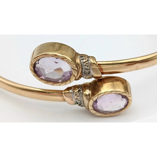 51 - A 9K GOLD TORQUE STYLE BANGLE WITH 2 PALE AMETHYST STONES , (ONE SMALL KINK HENCE LOW PRICE)    8.8g... 