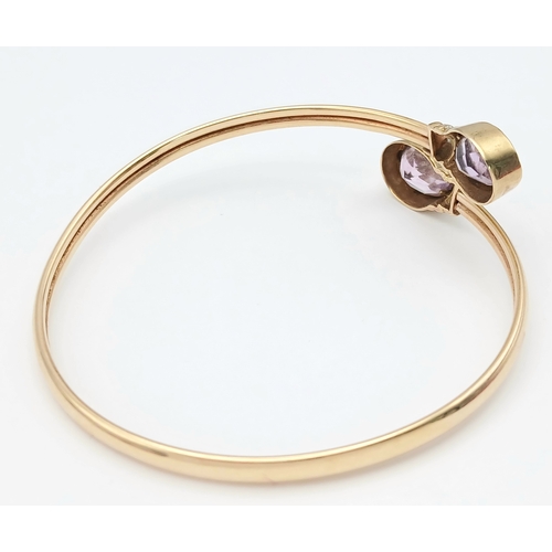 51 - A 9K GOLD TORQUE STYLE BANGLE WITH 2 PALE AMETHYST STONES , (ONE SMALL KINK HENCE LOW PRICE)    8.8g... 