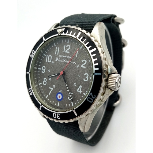 670 - A BEN SHERMAN, THE ORIGINAL, GREY MILITARY MATERIAL STRAP WATCH. IN FULL WORKING ORDER AND WITH ORIG... 