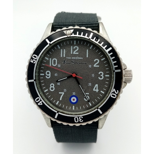 670 - A BEN SHERMAN, THE ORIGINAL, GREY MILITARY MATERIAL STRAP WATCH. IN FULL WORKING ORDER AND WITH ORIG... 
