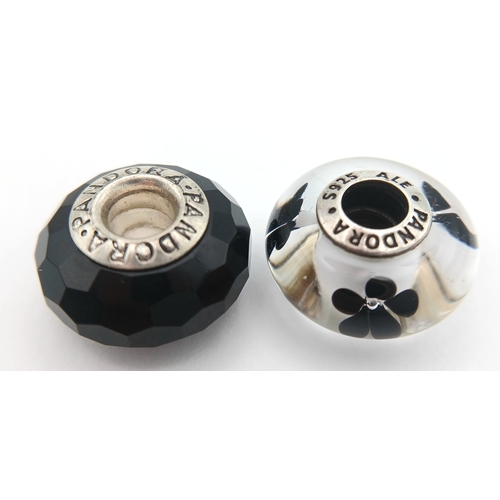 705 - A PAIR OF PANDORA, STERLING SILVER CHARMS. BLACK MURANO GLASS AND BLACK CHERRY BLOSSOM MURANO GLASS.... 