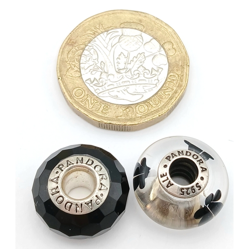 705 - A PAIR OF PANDORA, STERLING SILVER CHARMS. BLACK MURANO GLASS AND BLACK CHERRY BLOSSOM MURANO GLASS.... 