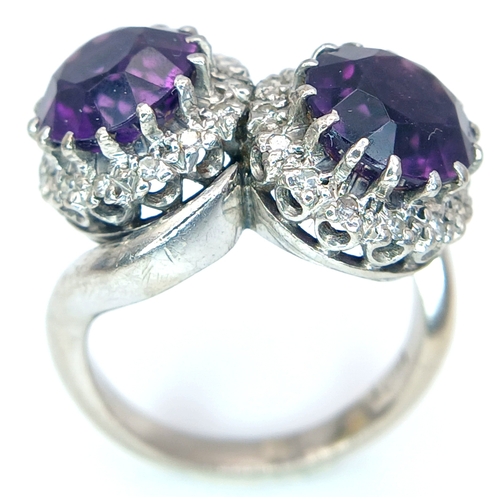 9 - A STUNNING 18K WHITE GOLD CROSSOVER RING WITH 2 X 2cwt OF ALEXANDRITE STONES SURROUNDED BY A HALO OF... 