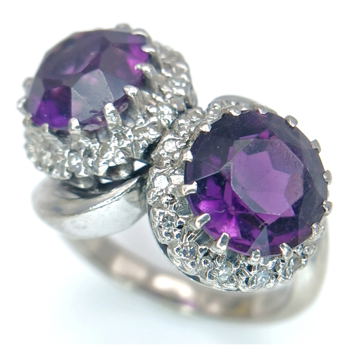 9 - A STUNNING 18K WHITE GOLD CROSSOVER RING WITH 2 X 2cwt OF ALEXANDRITE STONES SURROUNDED BY A HALO OF... 