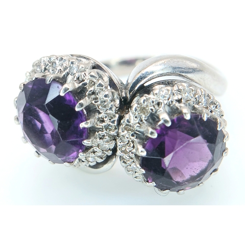 9 - A STUNNING 18K WHITE GOLD CROSSOVER RING WITH 2 X 2cwt OF ALEXANDRITE STONES SURROUNDED BY A HALO OF... 