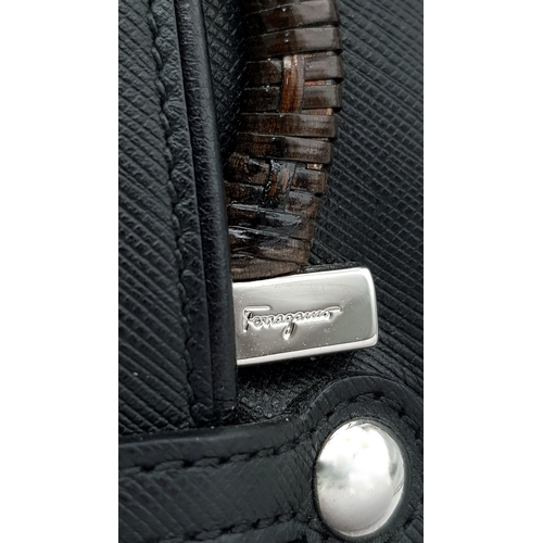 1195 - A Salvatore Ferragamo Black Leather Handbag. Crafted in structured black leather with silver-tone ha... 