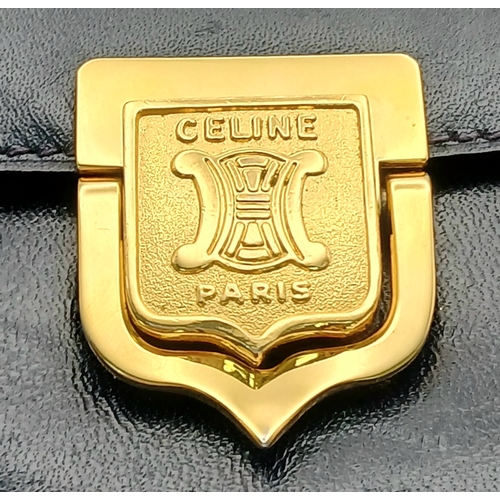 1202 - A Céline Vintage Navy Triomphe Shoulder Bag. Navy leather exterior with gold-tone hardware, Triomphe... 