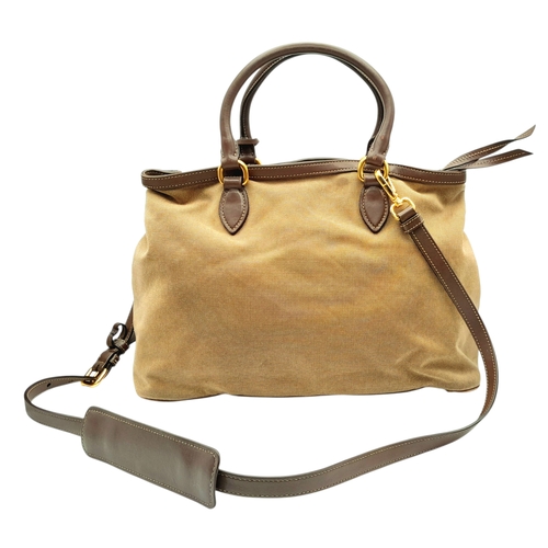 1216 - A Prada Beige Canvas and Brown Leather Tote Bag. Crafted in beige canvas with an embroidered “PRADA ... 