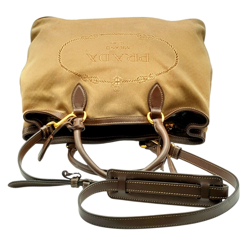 1216 - A Prada Beige Canvas and Brown Leather Tote Bag. Crafted in beige canvas with an embroidered “PRADA ... 
