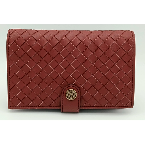 1241 - A Bottega Veneta Burgundy Wallet. Intrecciato leather exterior with gold-toned hardware, zipped coin... 