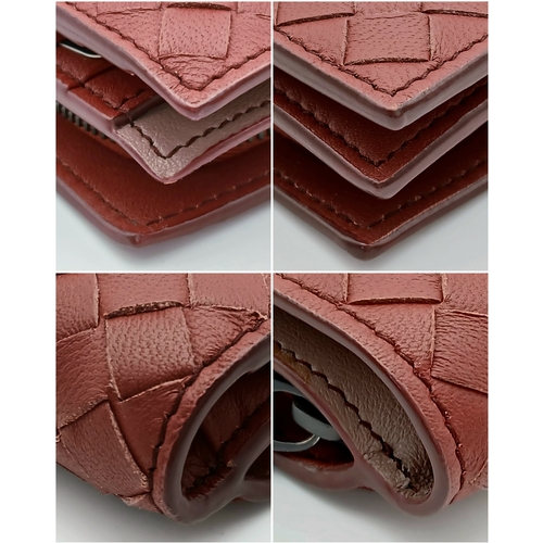 1241 - A Bottega Veneta Burgundy Wallet. Intrecciato leather exterior with gold-toned hardware, zipped coin... 