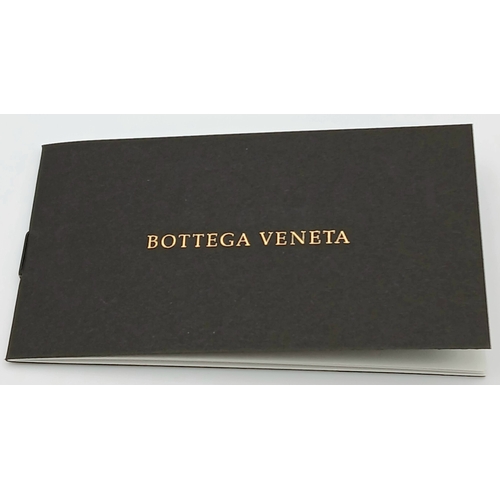 1241 - A Bottega Veneta Burgundy Wallet. Intrecciato leather exterior with gold-toned hardware, zipped coin... 