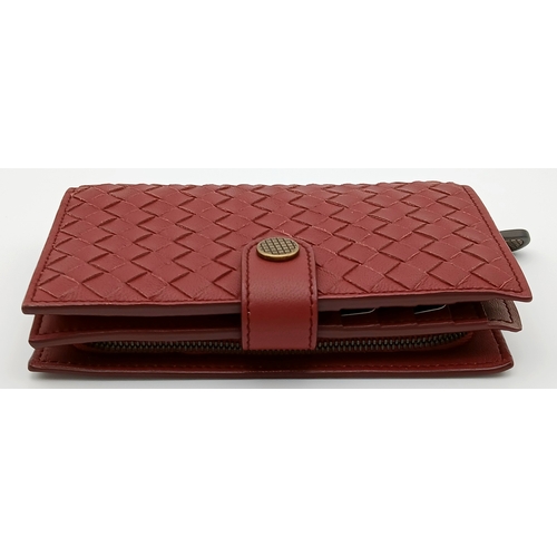 1241 - A Bottega Veneta Burgundy Wallet. Intrecciato leather exterior with gold-toned hardware, zipped coin... 