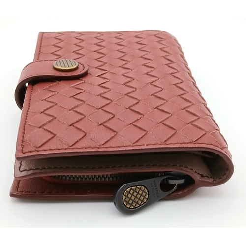 1241 - A Bottega Veneta Burgundy Wallet. Intrecciato leather exterior with gold-toned hardware, zipped coin... 