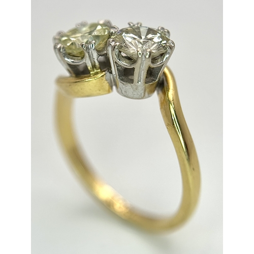 674 - An 18K Yellow Gold Diamond Crossover Ring. A 1ct round brilliant cut diamond having I colour and com... 