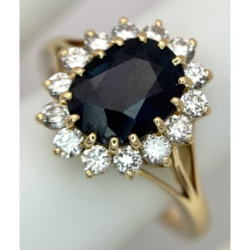 1243 - A Classic 18K Yellow Gold, Sapphire and Diamond Ring. Gorgeous 2ct oval cut green sapphire with 0.70... 