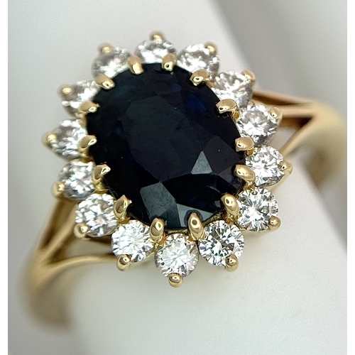 1243 - A Classic 18K Yellow Gold, Sapphire and Diamond Ring. Gorgeous 2ct oval cut green sapphire with 0.70... 