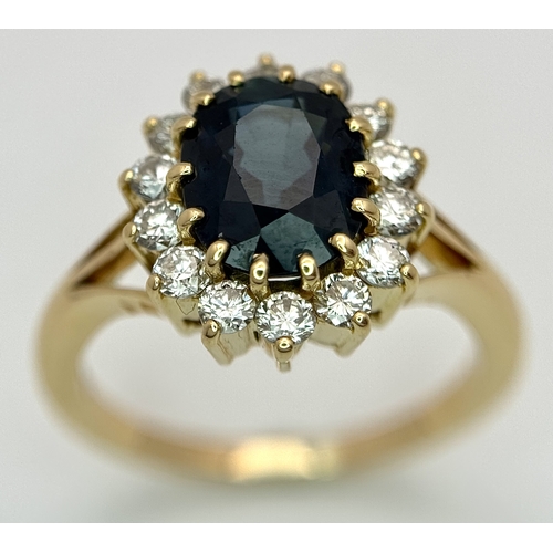 1243 - A Classic 18K Yellow Gold, Sapphire and Diamond Ring. Gorgeous 2ct oval cut green sapphire with 0.70... 