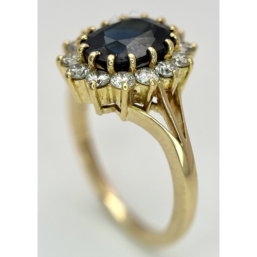 1243 - A Classic 18K Yellow Gold, Sapphire and Diamond Ring. Gorgeous 2ct oval cut green sapphire with 0.70... 