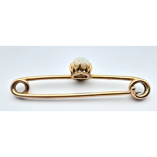 103 - A 9K GOLD BAR BROOCH WITH AN OVAL OPAL STONE .    2.7gms
