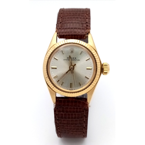 177 - A 18K Gold Rolex Oyster Perpetual Gold Ladies Automatic Watch. Brown leather strap. 18K gold case. S... 
