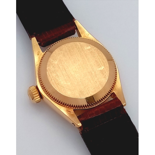 177 - A 18K Gold Rolex Oyster Perpetual Gold Ladies Automatic Watch. Brown leather strap. 18K gold case. S... 