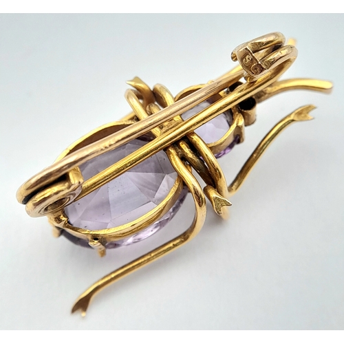 79 - AN ANTIQUE 9K GOLD AND AMETHYST BEETLE BROOCH .   4.2gms