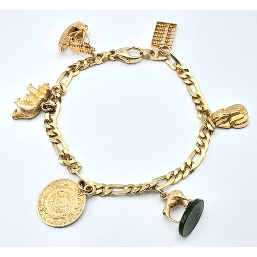 646 - A 14K GOLD CHARM BRACELET WITH 6 CHARMS .     21.9gms 
   19cms