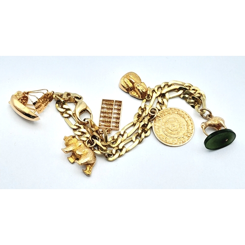 646 - A 14K GOLD CHARM BRACELET WITH 6 CHARMS .     21.9gms 
   19cms