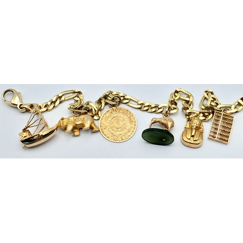 646 - A 14K GOLD CHARM BRACELET WITH 6 CHARMS .     21.9gms 
   19cms