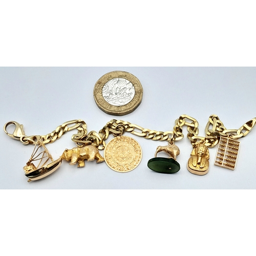 646 - A 14K GOLD CHARM BRACELET WITH 6 CHARMS .     21.9gms 
   19cms