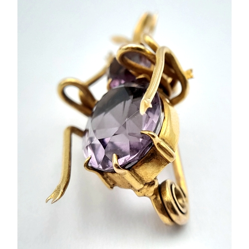 79 - AN ANTIQUE 9K GOLD AND AMETHYST BEETLE BROOCH .   4.2gms