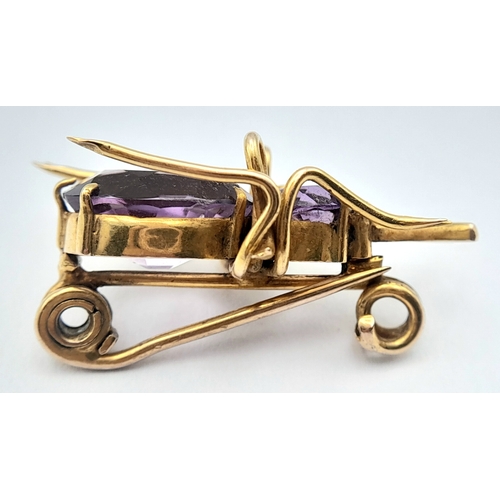 79 - AN ANTIQUE 9K GOLD AND AMETHYST BEETLE BROOCH .   4.2gms